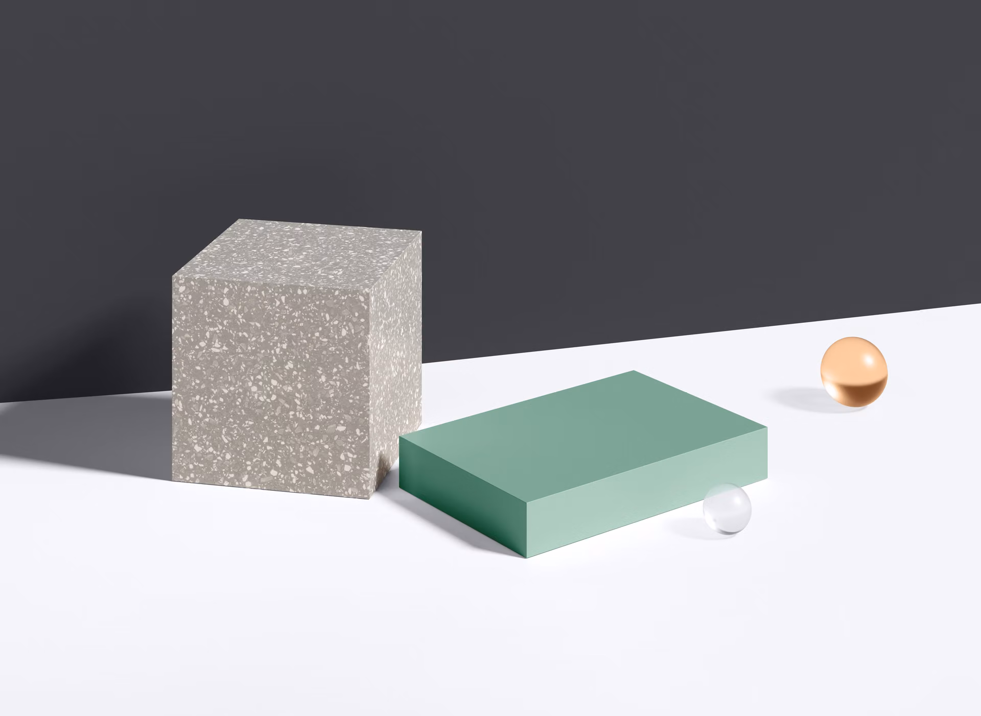 Abstract geometric scene with a gray terrazzo block, a mint rectangular block, and small colored spheres on gray and white planes.